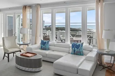 a living room with a white couch and a table at BEAUTIFUL GULF VIEWS Spacious, Updated 316B WaterSound Crossings Steps to Beach and Pool condo in Panama City Beach