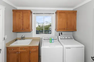 a kitchen with a washer and a sink and a window at BEAUTIFUL GULF VIEWS Spacious, Updated 316B WaterSound Crossings Steps to Beach and Pool condo in Panama City Beach
