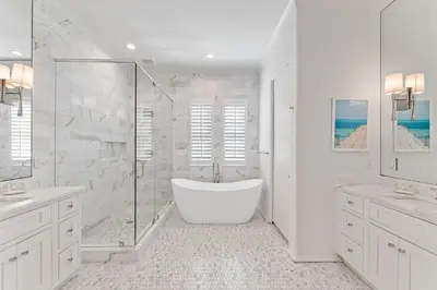 a white bathroom with a tub and a shower at Gulf Front Luxurious Home with Private Pool and Beach Access home in Panama City Beach