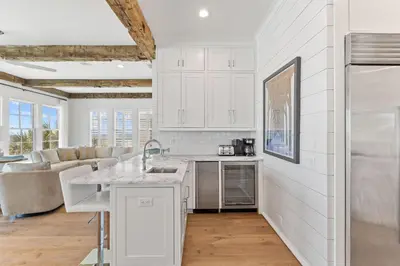 a kitchen with white cabinets and a counter top at Gulf Front Luxurious Home with Private Pool and Beach Access home in Panama City Beach