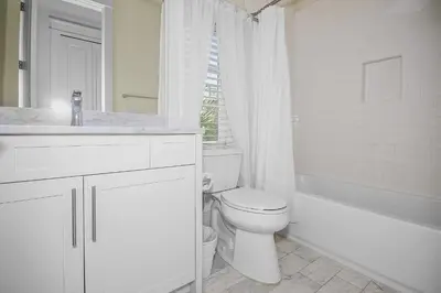 a white bathroom with a toilet and a sink and a tub at Gulf Views, Private Pool, Luxurious Home - Vista Del Mare home in Santa Rosa Beach
