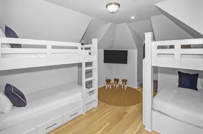 a bedroom with two bunk beds and a tv at Gulf Views, Private Pool, Luxurious Home - Vista Del Mare home in Santa Rosa Beach