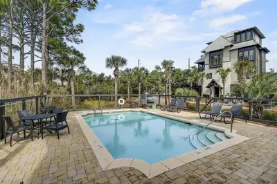 a swimming pool with chairs and a table next to a house at Gulf Views, Private Pool, Luxurious Home - Vista Del Mare home in Santa Rosa Beach