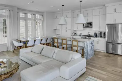 a white living room with a couch and a kitchen at Gulf Views, Private Pool, Luxurious Home - Vista Del Mare home in Santa Rosa Beach