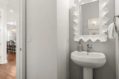 a bathroom with a sink and a mirror on the wall at Luxurious 