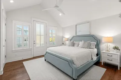 a bedroom with a blue bed and white walls at Luxurious 
