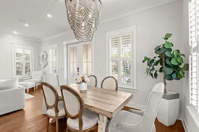 a dining room with a wooden table and chairs at Luxurious 