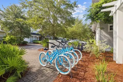 a row of blue bikes parked next to a house at Charming 4 BR Family Beach Retreat - 25 Half Moon, WaterSound West Beach home in Panama City Beach