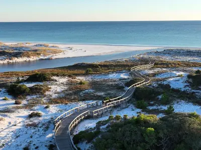 a wooden staircase leading to a beach with the ocean at Charming 4 BR Family Beach Retreat - 25 Half Moon, WaterSound West Beach home in Panama City Beach