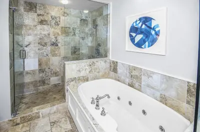 a bathroom with a white tub and a shower at STUNNING GULF VIEWS - 3BR WaterSound Condo #426A - Steps to Beach and Pool condo in Panama City Beach