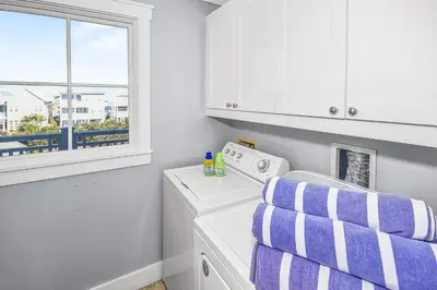 a laundry room with a washing machine and a window at STUNNING GULF VIEWS - 3BR WaterSound Condo #426A - Steps to Beach and Pool condo in Panama City Beach
