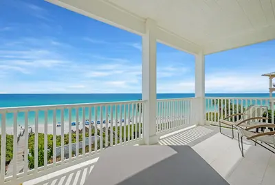 a screened porch with a view of the ocean at Shellstone Cottage - Beach Front Seacrest Home with Private Pool and 5 Bedrooms home in Inlet Beach