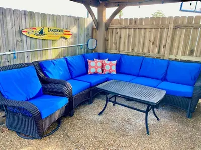 a blue couch and two chairs and a table at Anchors Away - Private Pool, Seasonal Hot Tub, Game Room, Walk to Beach, Pets OK in Panama City Beach