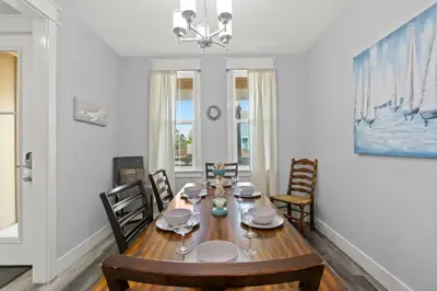 a dining room with a wooden table and chairs at Sandy Palms - Pool & Hot Tub, 3 Min Walk to the Beach, w Golf Cart & Beach Gear in Panama City Beach