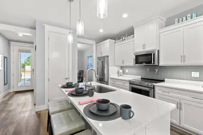 a kitchen with white cabinets and a white counter top at Sandy Palms - Pool & Hot Tub, 3 Min Walk to the Beach, w Golf Cart & Beach Gear in Panama City Beach