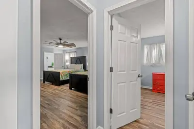 an open door to a room with a bedroom at Tiki Hut - Private Pool Home, Game Room, 5 Min Drive 2 Beach, FREE Daily Activities in Panama City Beach