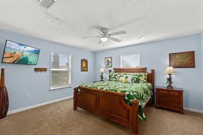 a bedroom with a bed and a ceiling fan at Pirates Cove - Private Pool, Seasonal Hot Tub, Game Room, Close to Beach, Pets OK in Panama City Beach