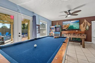 a billiard room with a pool table and a tv at Pirates Cove - Private Pool, Seasonal Hot Tub, Game Room, Close to Beach, Pets OK in Panama City Beach