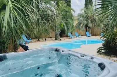 a swimming pool with a jacuzzi tub in a yard at Pirates Cove - Private Pool, Seasonal Hot Tub, Game Room, Close to Beach, Pets OK in Panama City Beach