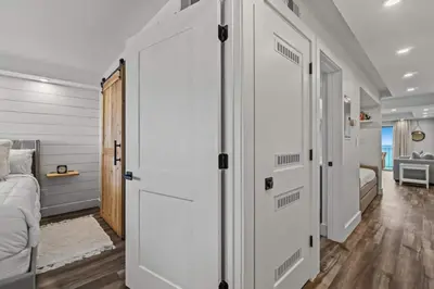 a bedroom with a door leading to a bedroom with a bed at Summit 803 - Luxury Beach Resort Condo 1-6 People in Panama City Beach