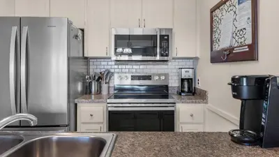 a kitchen with a stainless steel stove and refrigerator at Blue Nine 3 in Panama City Beach