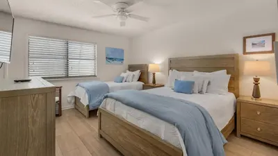 a bedroom with two beds and a ceiling fan at Blue Nine 3 in Panama City Beach