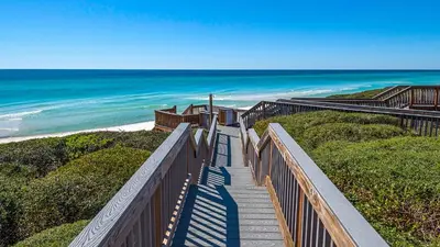 a stairway leading down to a beach with the ocean at Blue Nine 3 in Panama City Beach
