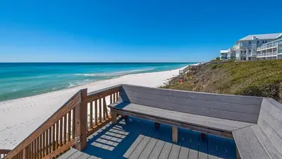 a wooden bench sitting on top of a beach at Blue Nine 3 in Panama City Beach