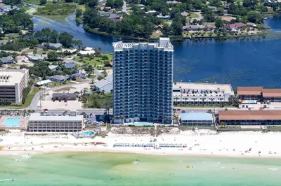 an aerial view of a beach with a tall building at Sterling Breeze 804 in Panama City Beach