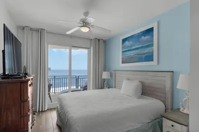 a bedroom with a bed and a view of the ocean at Sterling Breeze 804 in Panama City Beach