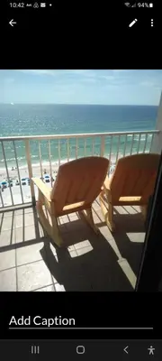 two chairs sitting on a balcony overlooking the ocean at The Summit Condo Resort in Panama City Beach