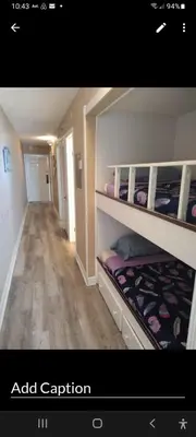 a room with two bunk beds and a hallway at The Summit Condo Resort in Panama City Beach