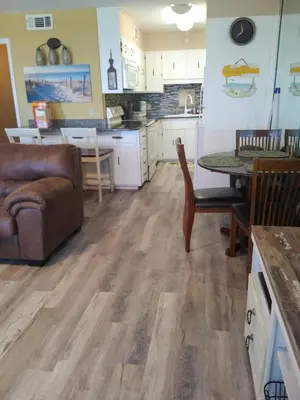 a kitchen and living room with a couch and a table at The Summit Condo Resort in Panama City Beach
