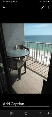 a balcony with a table and a view of the ocean at The Summit Condo Resort in Panama City Beach