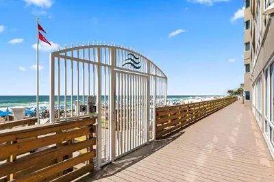 a boardwalk leading to the beach with a gate at Totally Beachin Unit 1302 in Panama City Beach