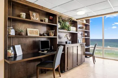 an office with a desk with a computer and chairs at Totally Beachin Unit 1302 in Panama City Beach