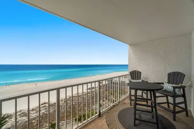 a balcony with a table and chairs and a view of the beach at Summit 808 - Luxury Beach Resort Condo 1-6 People in Panama City Beach