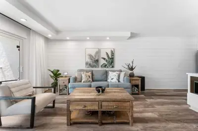 a living room with a blue couch and a coffee table at Summit 808 - Luxury Beach Resort Condo 1-6 People in Panama City Beach
