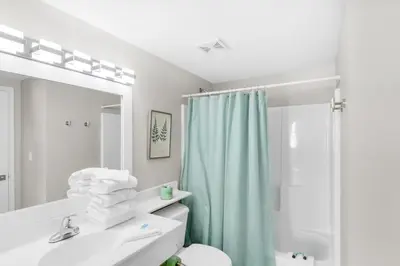 a bathroom with a sink and a toilet and a mirror at Shores of Panama 431 in Panama City Beach