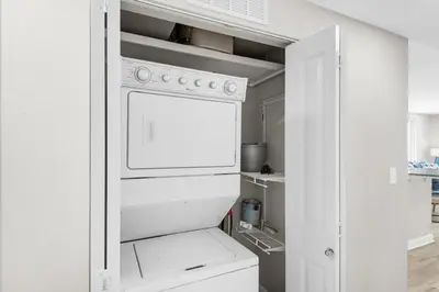 a white kitchen with a white stove top oven at Shores of Panama 431 in Panama City Beach