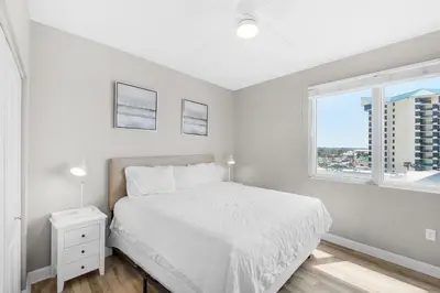 a white bedroom with a bed and a window at Shores of Panama 431 in Panama City Beach