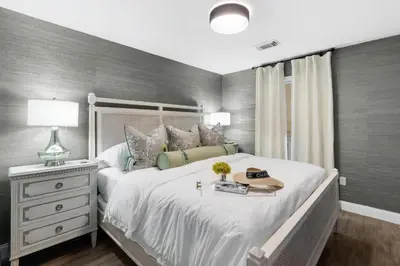 a bedroom with a large white bed and a night stand at Serenity by the Sea in Santa Rosa Beach