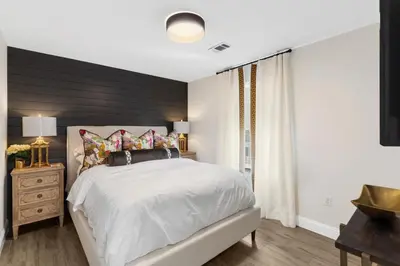 a bedroom with a bed and a dresser and a window at Serenity by the Sea in Santa Rosa Beach