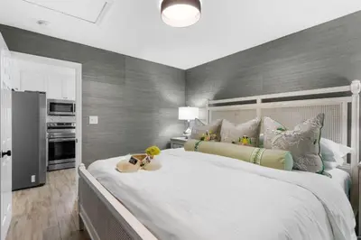 a bedroom with a large white bed with pillows at Serenity by the Sea in Santa Rosa Beach