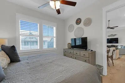 a bedroom with a bed and a flat screen tv at Totally Beachin' in Inlet Beach