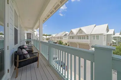 a porch of a house with a bench on it at Totally Beachin' in Inlet Beach