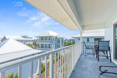 a balcony with two chairs and a table at Beachside Villas #731 in Santa Rosa Beach