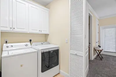 a kitchen with white cabinets and a dishwasher at LUV PCB by Sand Seeker Vacations in Panama City Beach