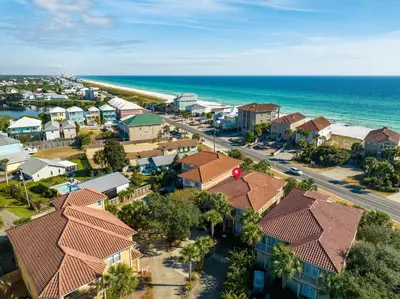 an aerial view of a residential neighborhood with the ocean at LUV PCB by Sand Seeker Vacations in Panama City Beach
