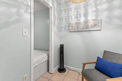 a living room with a couch and a mirror at Fanta Sea - Private Seasonal Hot Tub, Game Room, Walk to Beach, Pets OK, & More! in Panama City Beach